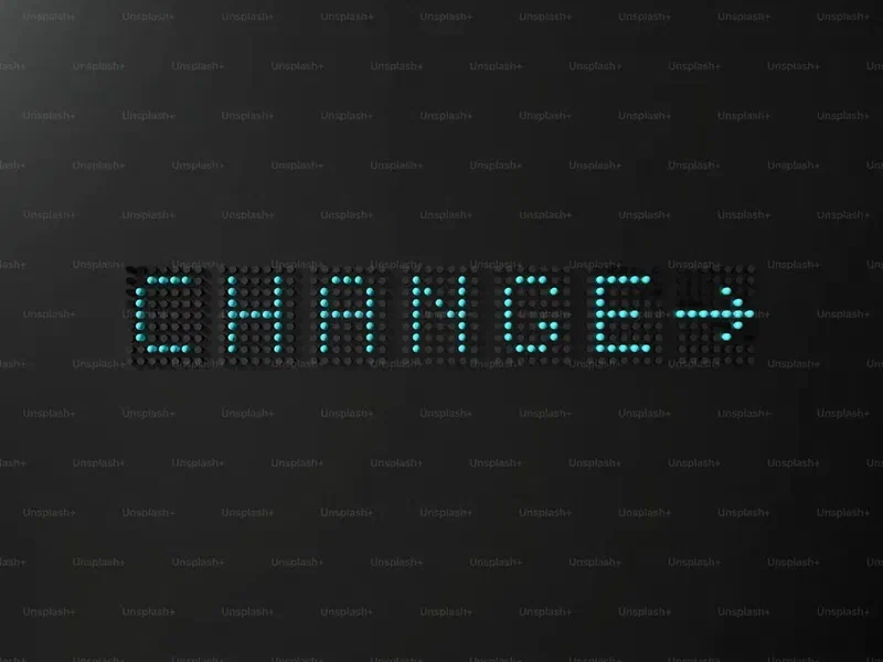 LED dot-matrix display showing the word “CHANGE” with a right-pointing arrow on a black background.